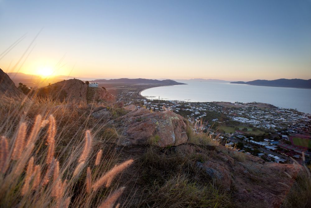A View Of A City From A Hill Overlooking A Body Of Water At Sunset — Life Legal in West End, QLD