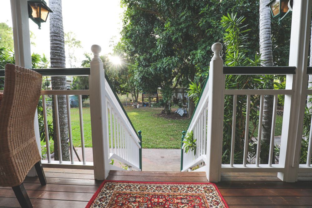A Porch With Stairs Leading Up To A Lush Green Yard — Life Legal in West End, QLD