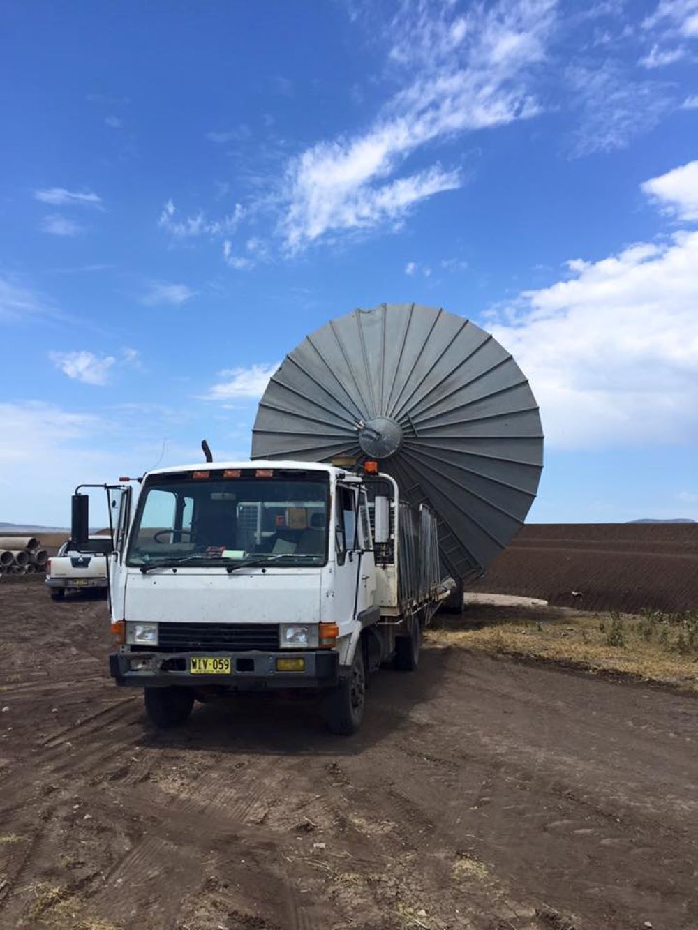 A White Truck With a Metal Structure Shaped like an umbrella on the back of it— Wallamore Grain & Produce In Barraba, NSW