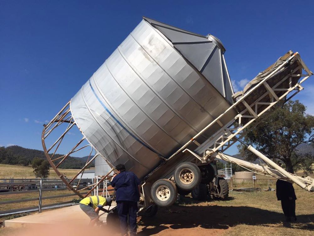 A Large Silo is getting transported by a trailer — Wallamore Grain & Produce In Barraba, NSW
