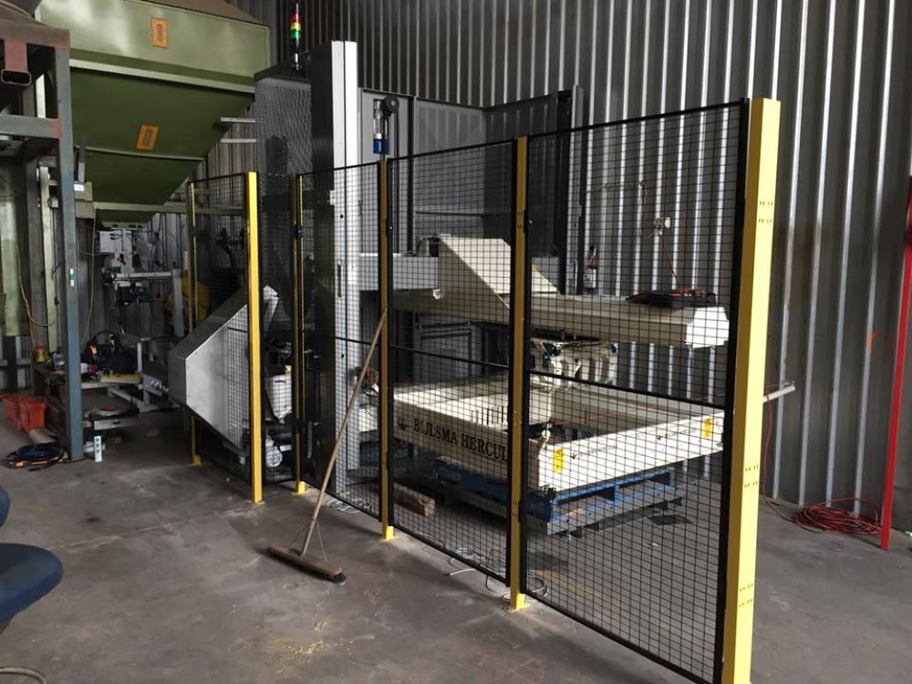 A Machine is Behind a Fence in a Factory — Wallamore Grain & Produce In Gunnedah, NSW