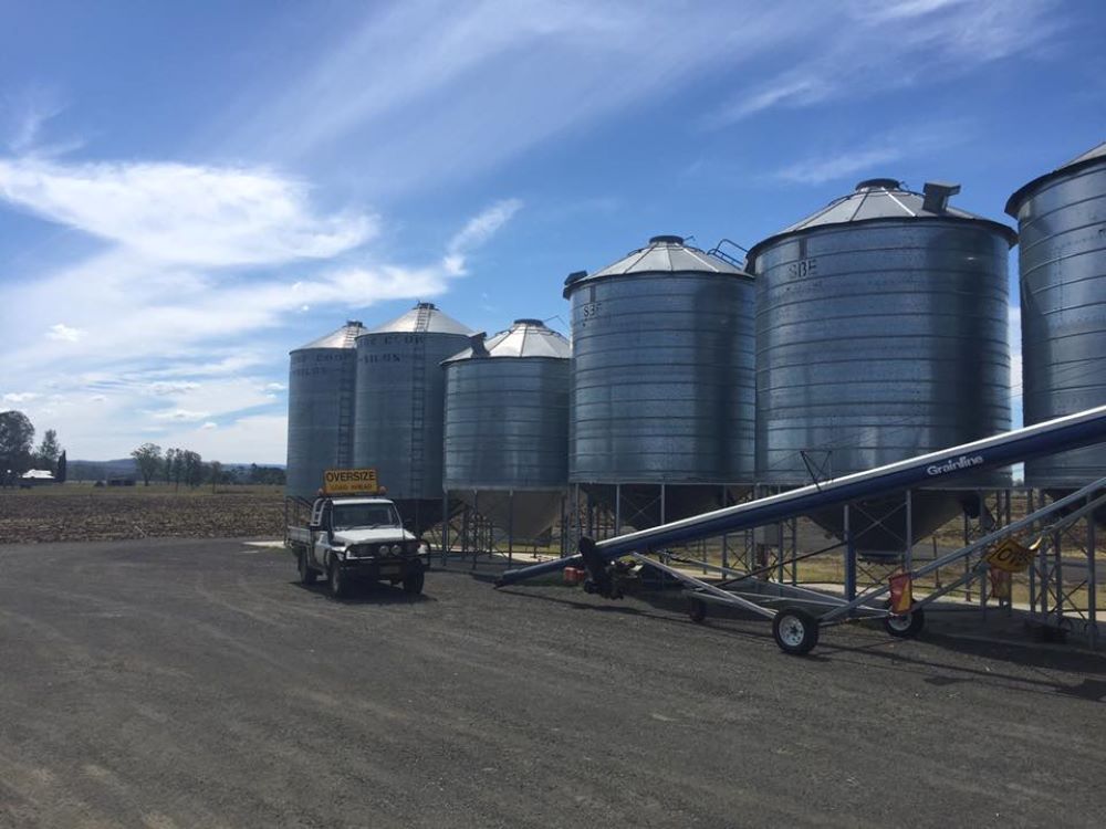 A Truck is Parked in Front of a Row of Silos — Wallamore Grain & Produce In Gunnedah, NSW
