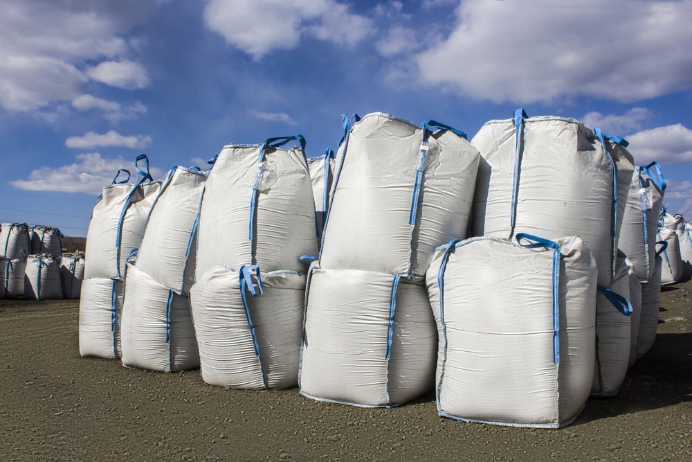 A Bunch of White Bags Are Stacked on Top of Each Other on the Ground — Wallamore Grain & Produce In Gunnedah, NSW
