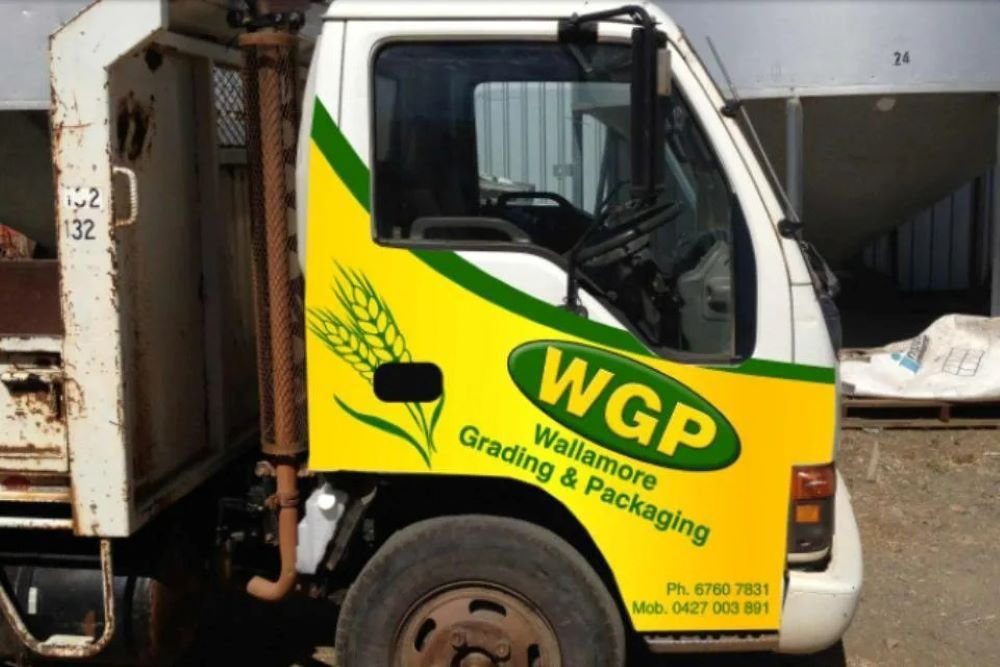 A White and Yellow Truck That Says WGP on the Side — Grain & Produce In Wallamore, NSW
