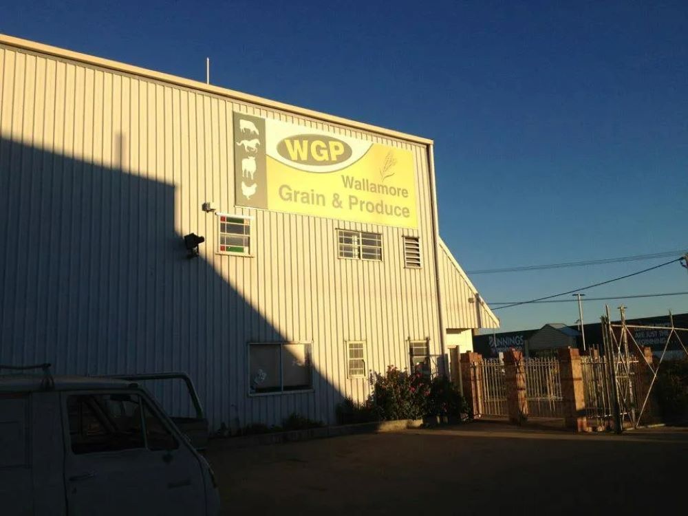 A White Building With a Sign That Says WGP on It — Wallamore Grain & Produce In Wallamore, NSW