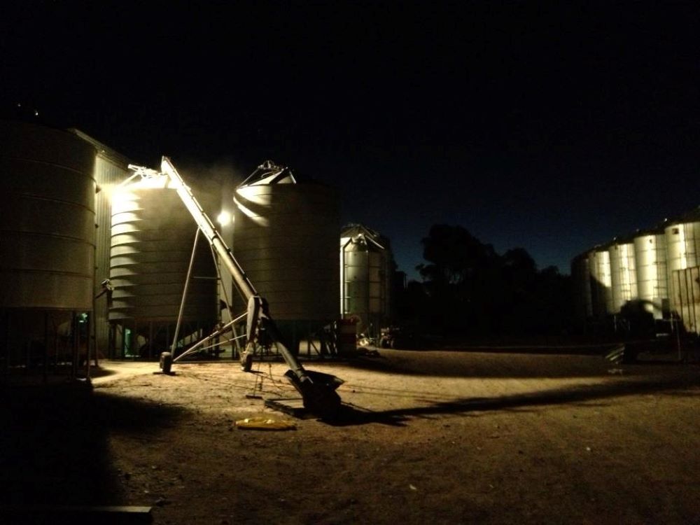 A Row of Silos Are Lit Up at Night — Wallamore Grain & Produce In Wallamore, NSW