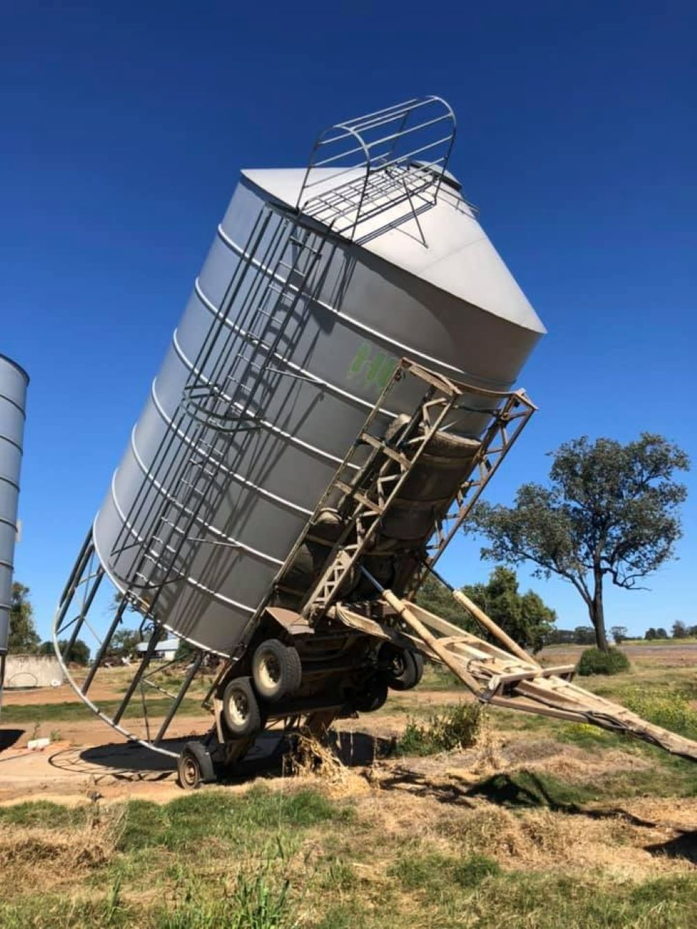 A Large Silo is Sitting on Top of a Trailer in a Field — Wallamore Grain & Produce In Wallamore, NSW