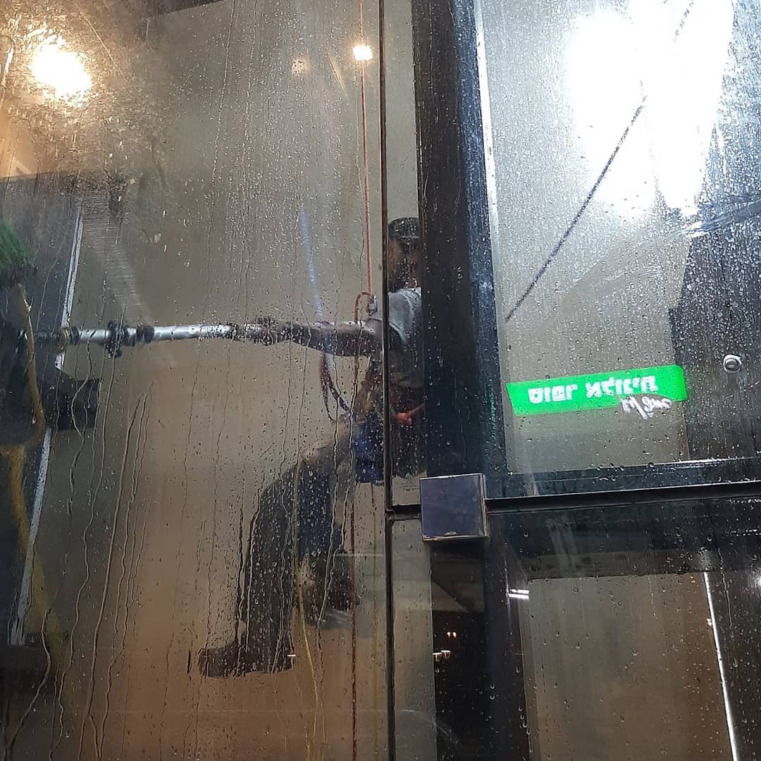 rappelling and cleaning elevator shaft