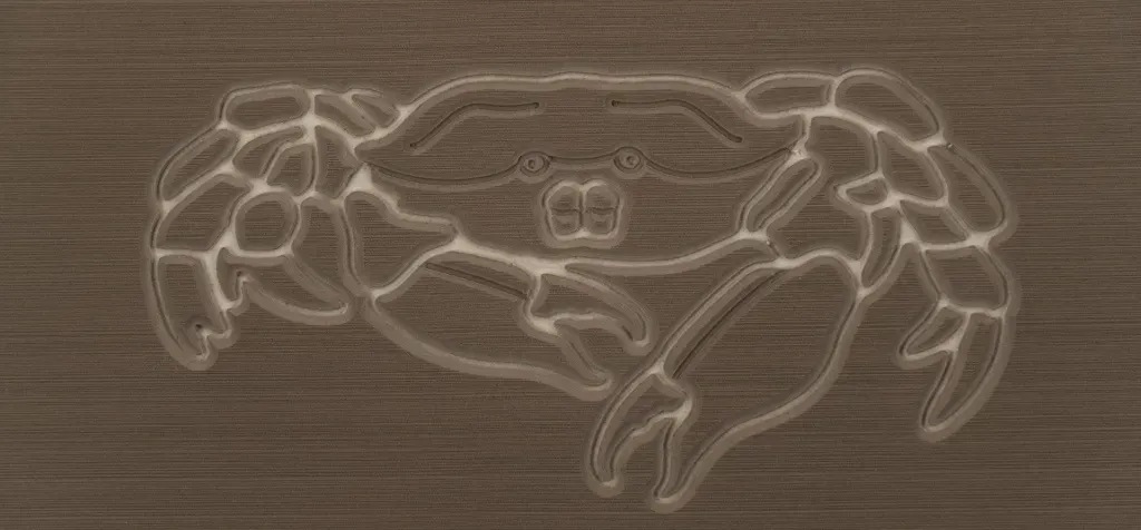 Crab carving on a wooden surface. The crab is in a side view, and its details are highlighted.