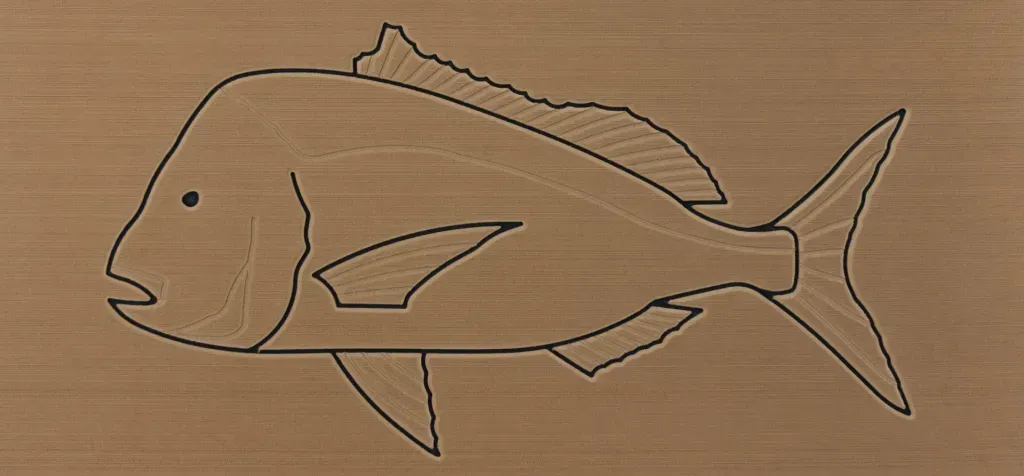 A fish outline carved into wood.