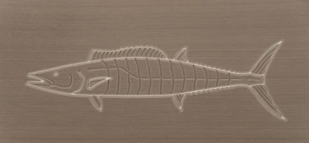 A detailed carving of a barracuda fish on a brown wooden surface.