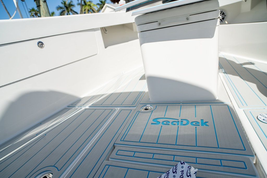 Boat deck with gray non-slip flooring and blue accents, SeaDek logo.