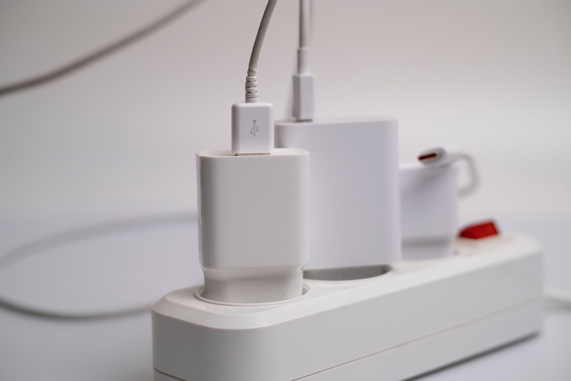 various charging cords plugged into a power supply