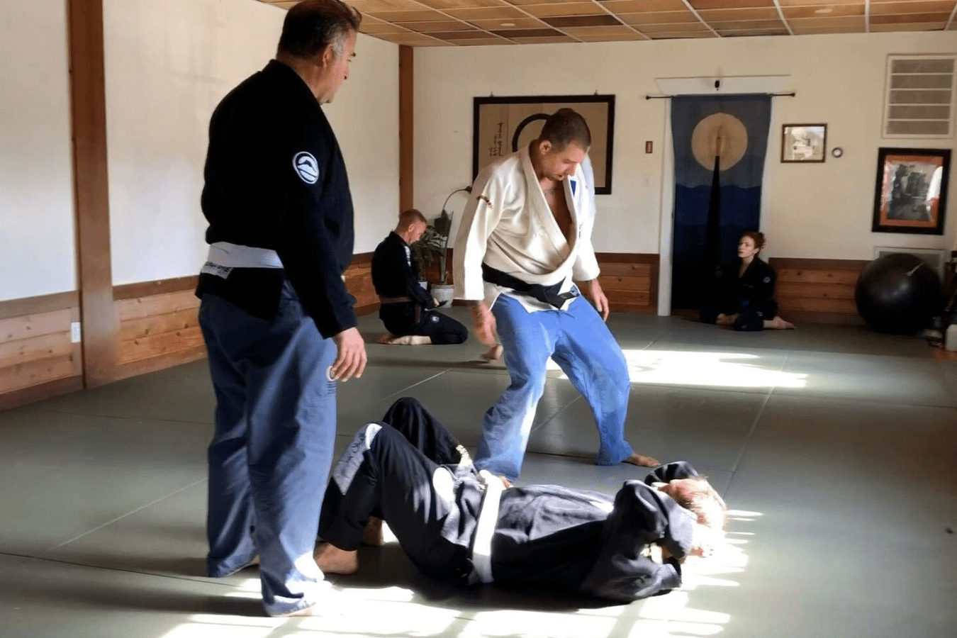 Adults practicing Brazilian Jiu-Jitsu drills at OM Brazilian Jiu-Jitsu & Judo in Northport, NY for fitness and self-defense.