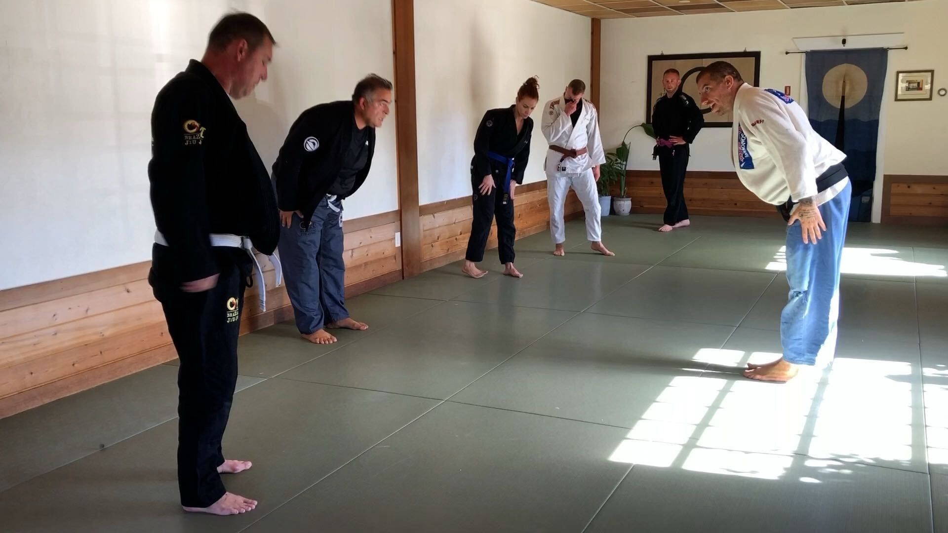Adults drilling Brazilian Jiu-Jitsu techniques at OM Brazilian Jiu-Jitsu & Judo in Northport, NY for fitness and stress relief