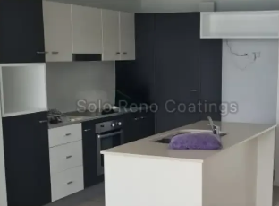 A kitchen with black and white cabinets — Solo Reno Coatings In Gold Coast, QLD
