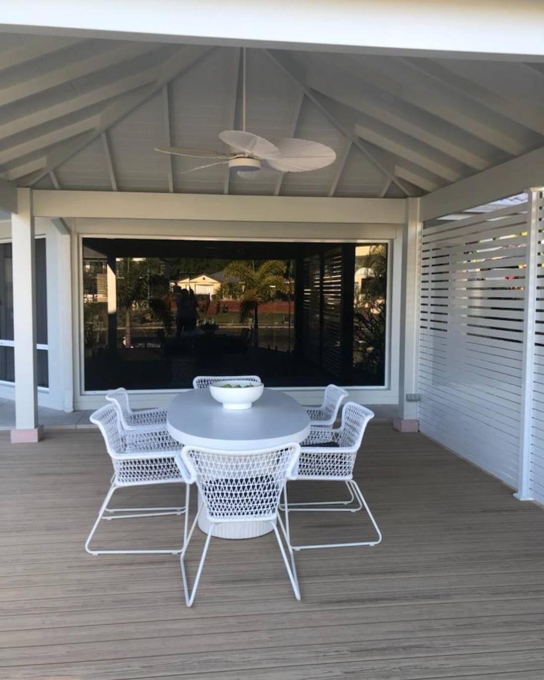 A patio with a table and chairs and a ceiling fan — Solo Reno Coatings In Gold Coast, QLD