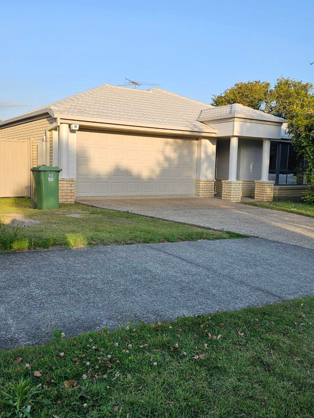 A white house with a green trash can in front of it — Solo Reno Coatings In Gold Coast, QLD