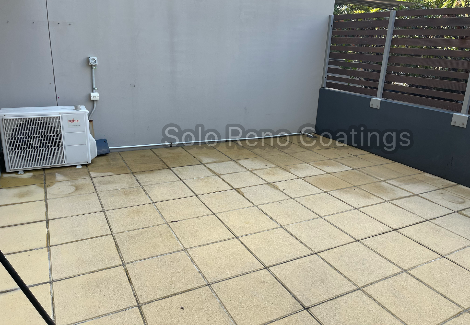 A Man Bending Over Paints And Tools On Tiles — Solo Reno Coatings In Gold Coast, QLD