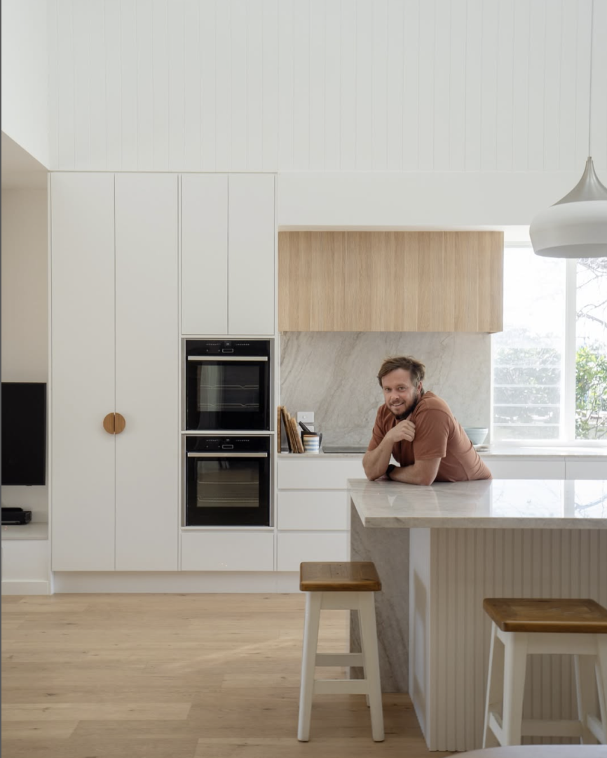 A Man In A Kitchen Leaning On A Kitchen Counter — DeBu Studios In Russell Vale, NSW