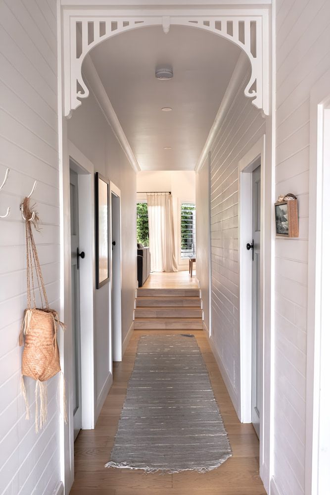 A Long Hallway With White Walls And A Rug On The Floor — DeBu Studios In Russell Vale, NSW