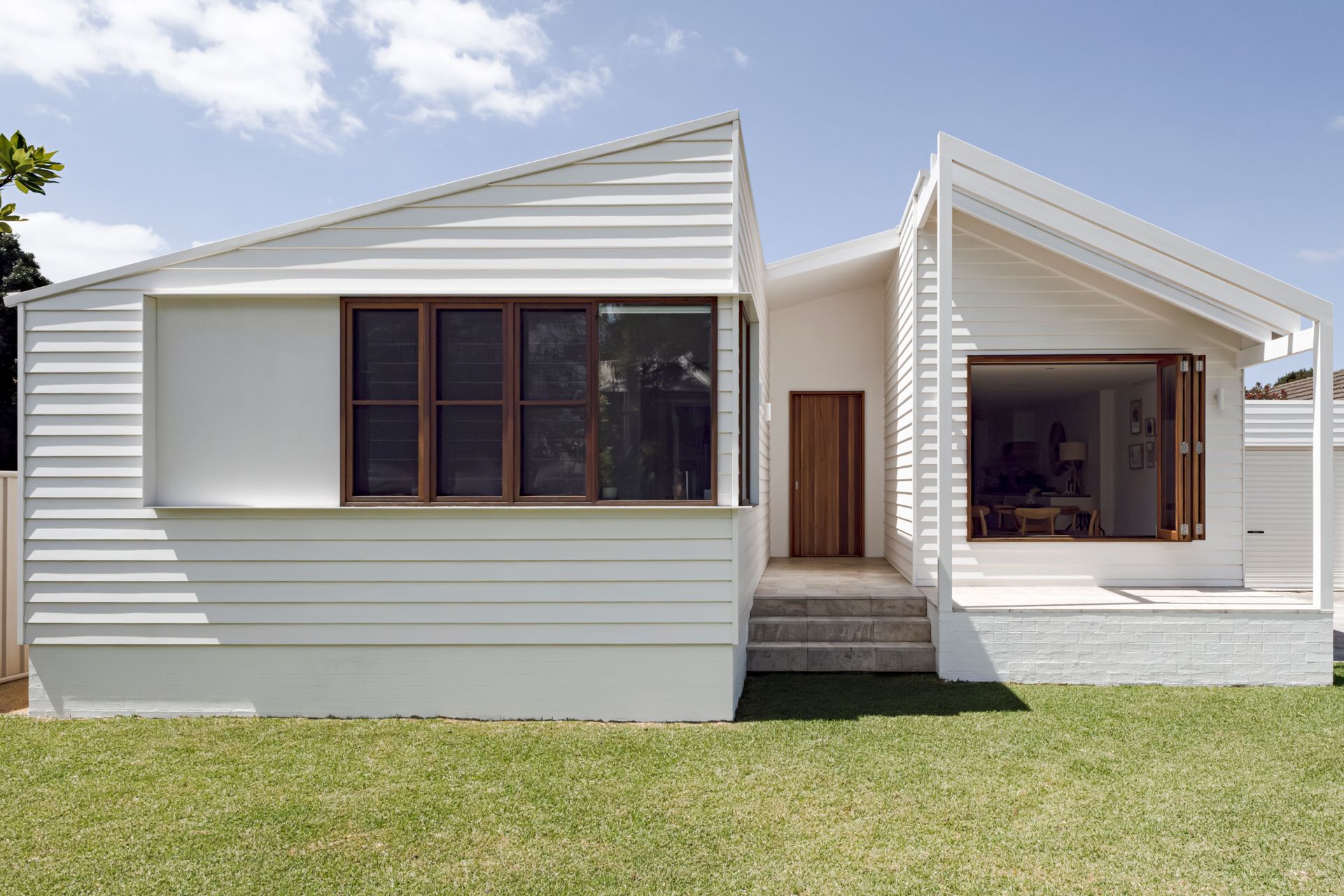 A large house with a white fence in front of it — DeBu Studios In Southern Sydney, NSW