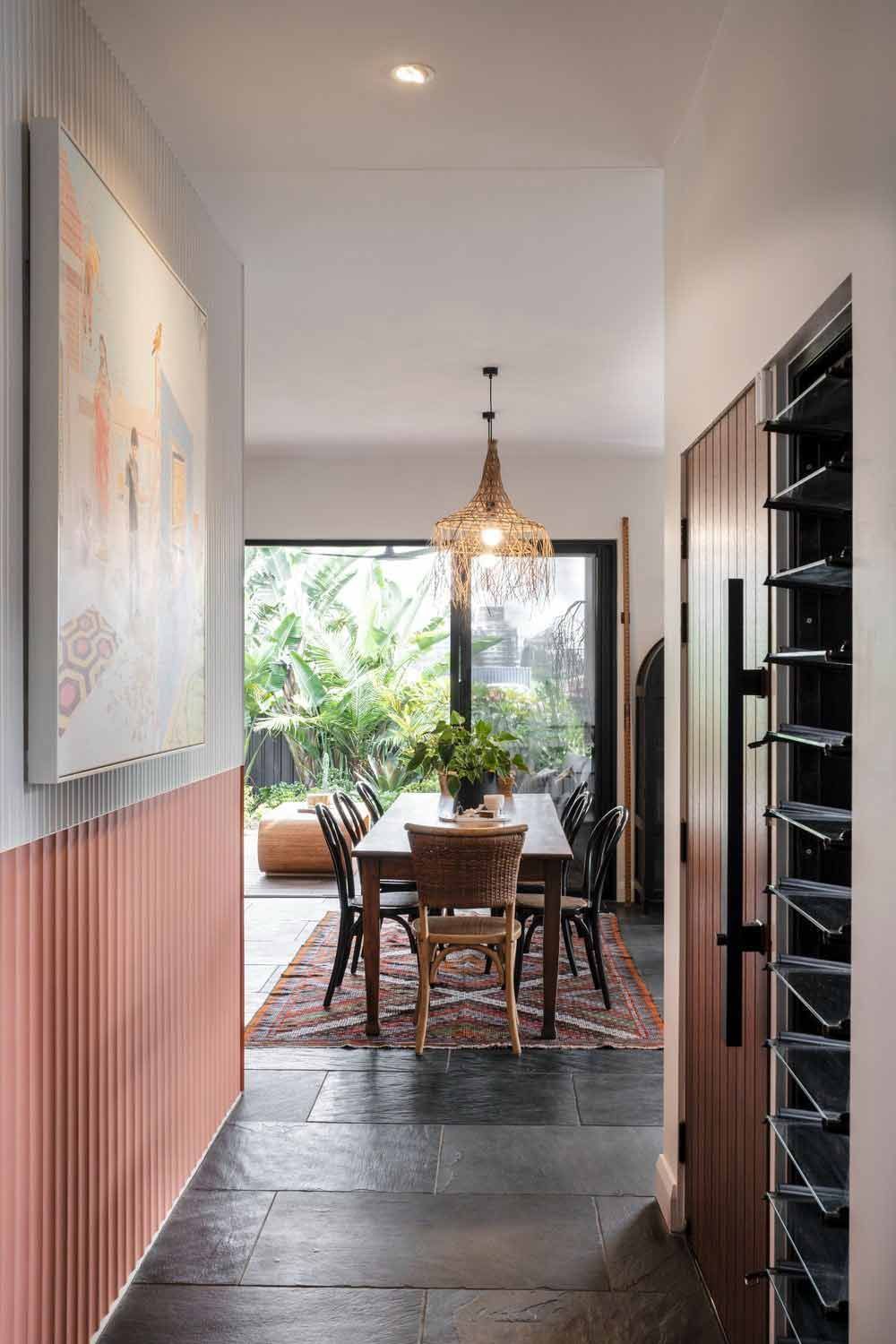 A Hallway Leading to a Dining Room With a Table and Chairs — DeBu Studios In Russell Vale, NSW