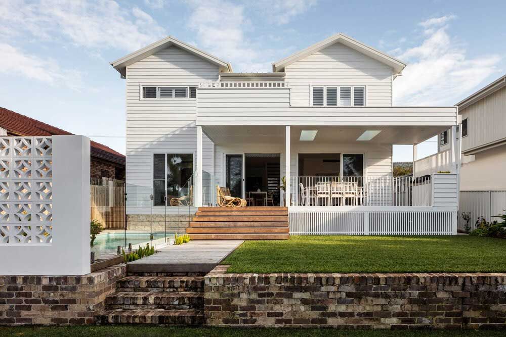 The Back of a White House With a Large Porch and a Brick Wall — DeBu Studios In Russell Vale, NSW
