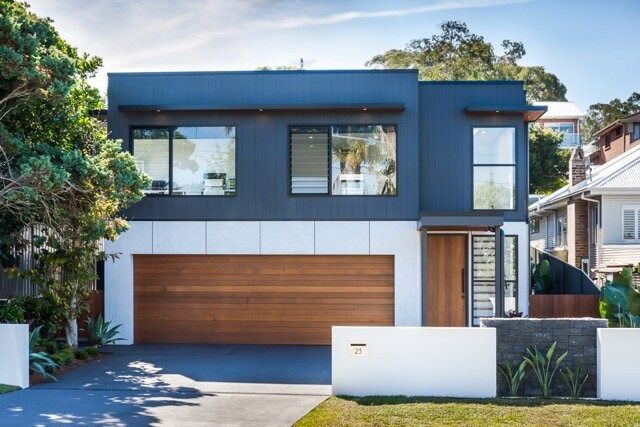 A Black and White House With a Wooden Garage Door — DeBu Studios In Russell Vale, NSW