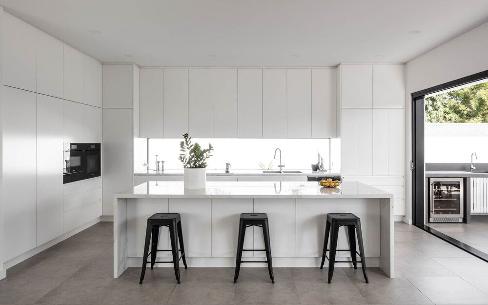 A Kitchen With White Cabinets and Black Stools — DeBu Studios In Russell Vale, NSW