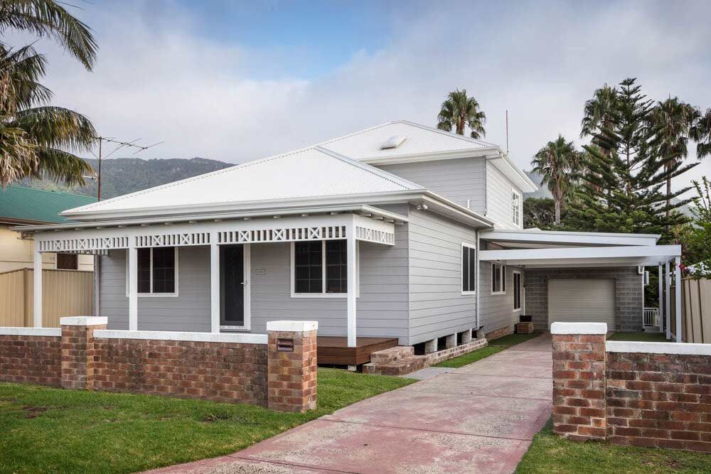 A White House With a Brick Walkway Leading to It — DeBu Studios In Russell Vale, NSW