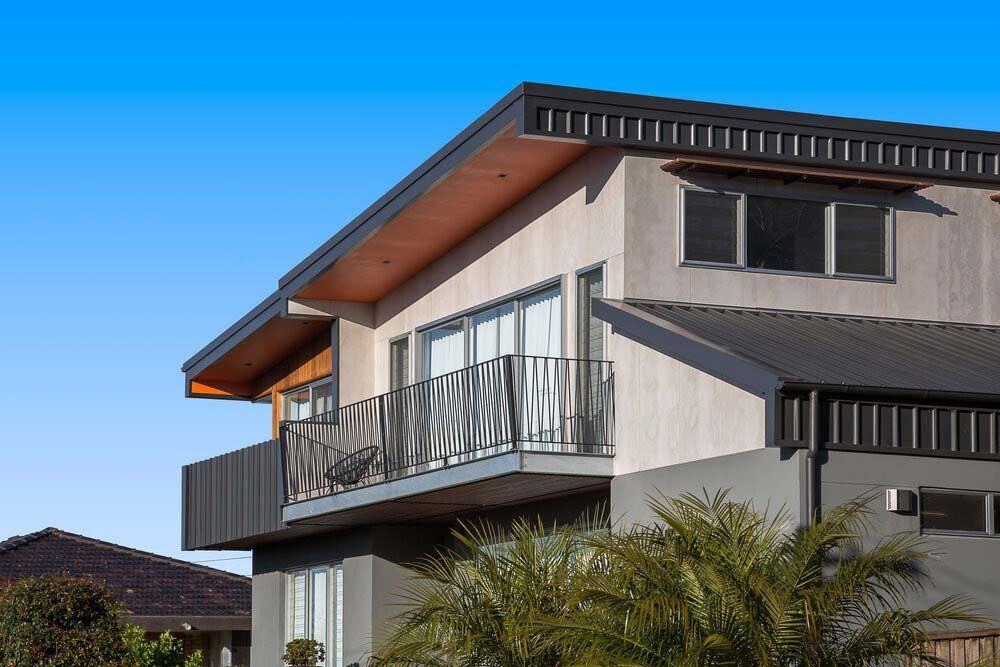 A Large House With a Balcony and a Blue Sky in the Background — DeBu Studios In Russell Vale, NSW