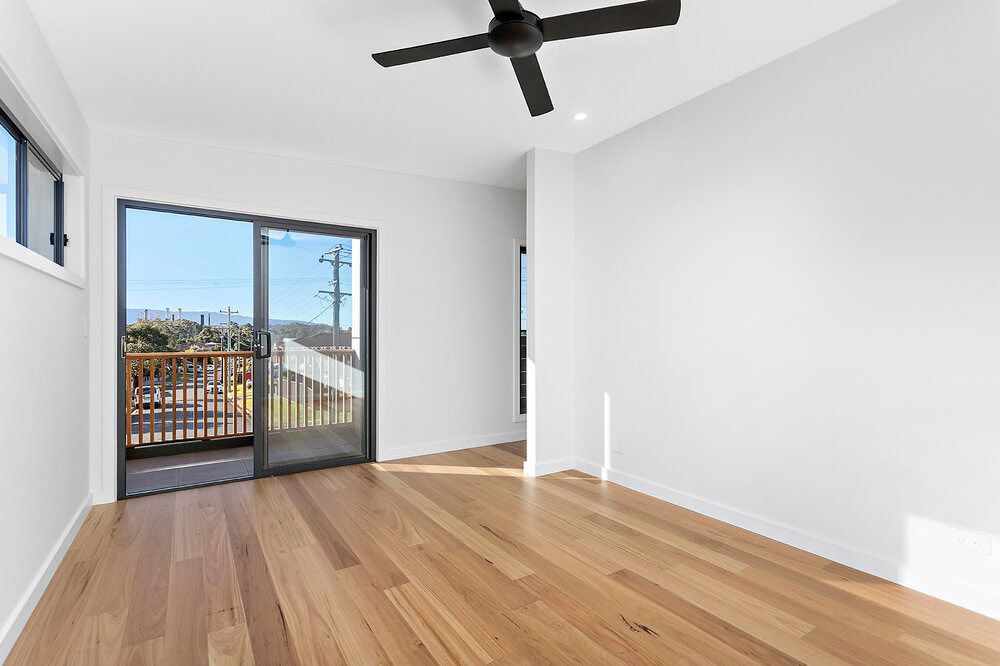 An Empty Room With Hardwood Floors and a Ceiling Fan — DeBu Studios In Russell Vale, NSW