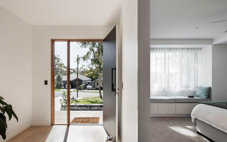 A Bedroom With a Sliding Glass Door and a Bed — DeBu Studios In Russell Vale, NSW