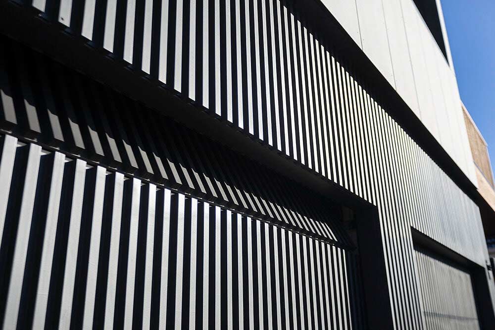 A Black and White Striped Wall With a Blue Sky in the Background — DeBu Studios In Russell Vale, NSW