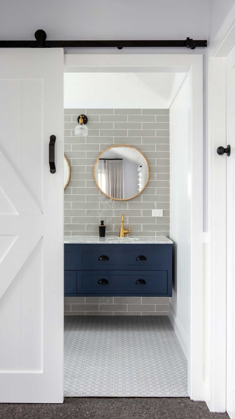 A Bathroom With a Sliding Barn Door and a Blue Vanity — DeBu Studios In Russell Vale, NSW