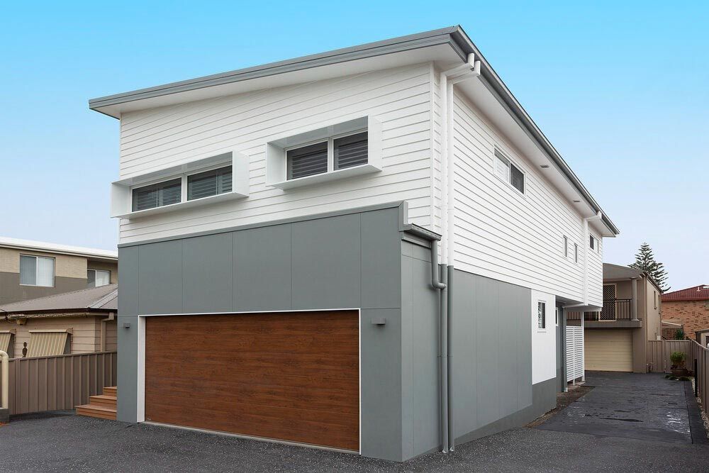 A White House With a Brown Garage Door — DeBu Studios In Russell Vale, NSW