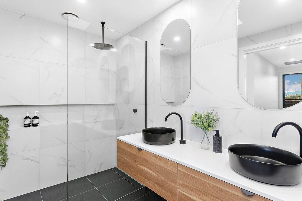 A Bathroom With Two Sinks, a Mirror and a Shower — DeBu Studios In Russell Vale, NSW