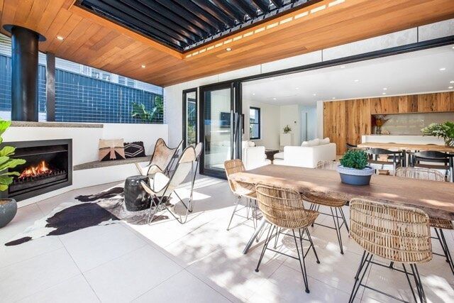 A Dining Room With a Table and Chairs and a Fireplace — DeBu Studios In Russell Vale, NSW