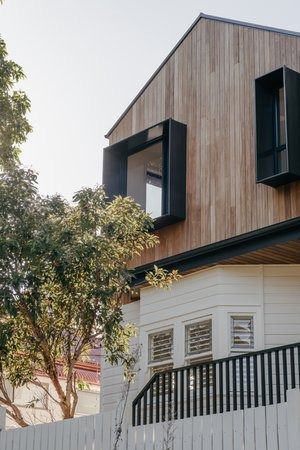 A House With a Wooden Roof and a White Fence in Front of It — DeBu Studios In Russell Vale, NSW