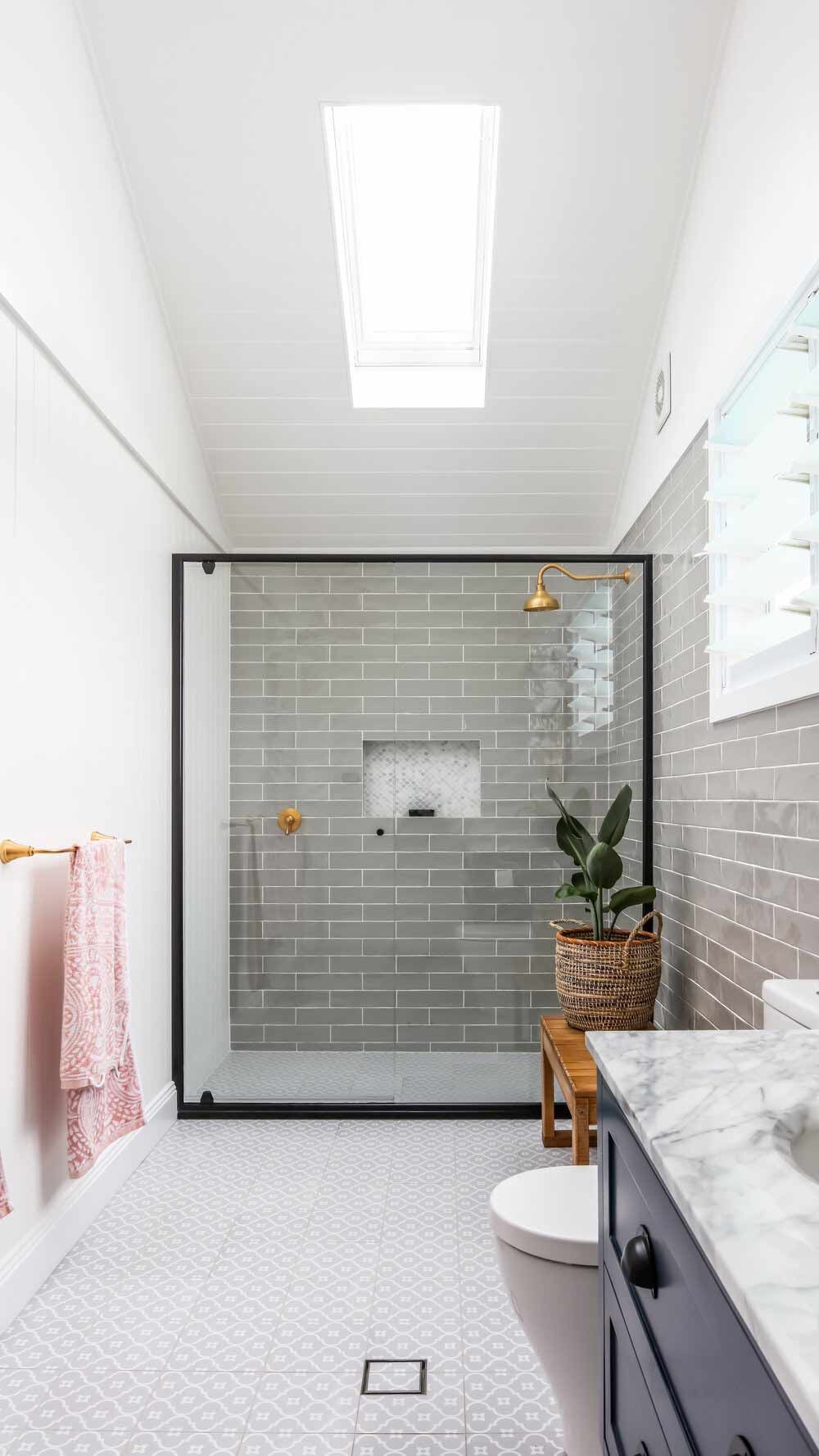 A Bathroom With a Toilet, Sink, Shower and Skylight — DeBu Studios In Russell Vale, NSW
