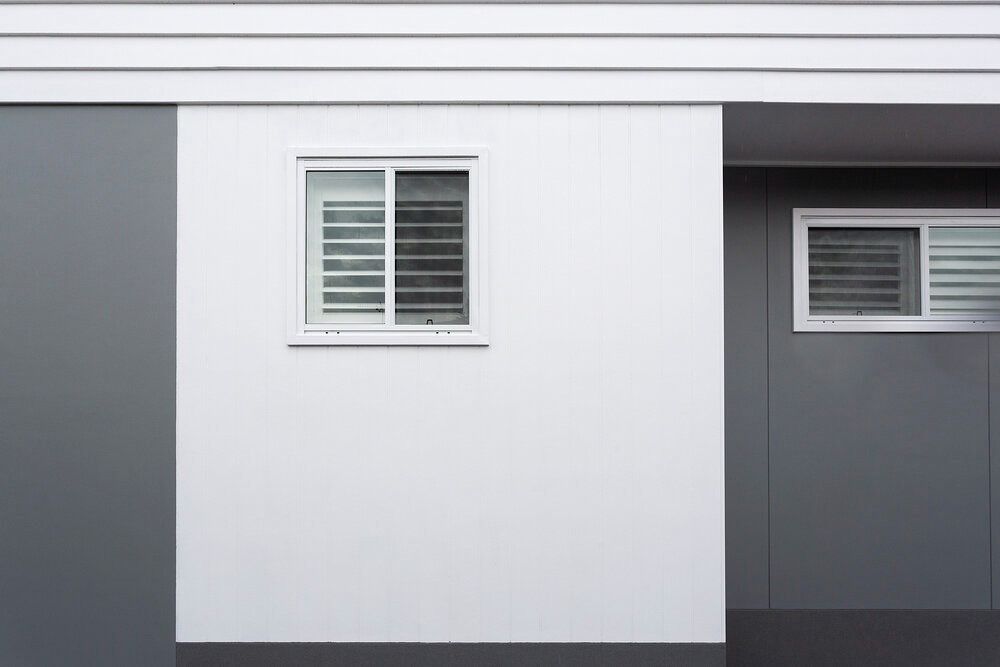 A White Wall With a Window and Shutters on It — DeBu Studios In Russell Vale, NSW