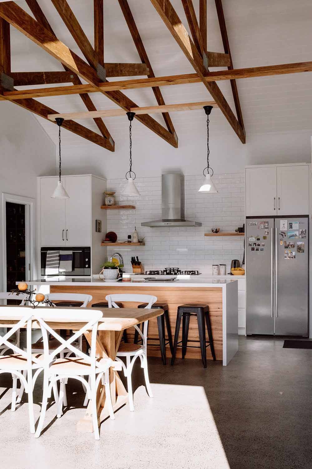 A Kitchen With a Table and Chairs and a Refrigerator — DeBu Studios In Russell Vale, NSW