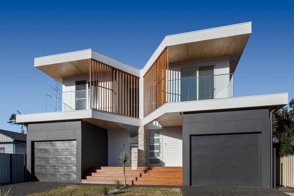 A Modern House With Two Garages and Stairs in Front of It — DeBu Studios In Russell Vale, NSW