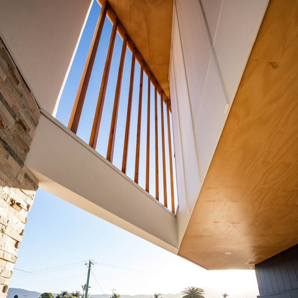 Looking Up at a Balcony With a Wooden Railing — DeBu Studios In Russell Vale, NSW