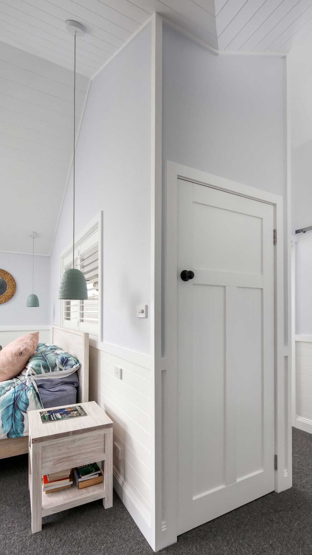 A Bedroom With a Bed, Nightstand, and Door — DeBu Studios In Russell Vale, NSW