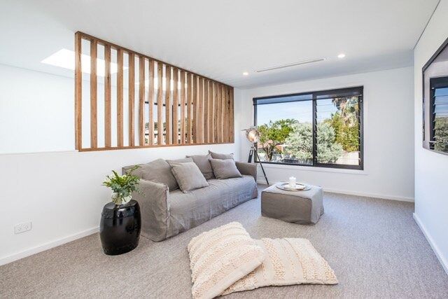 A Living Room With a Couch, Coffee Table, and Window — DeBu Studios In Russell Vale, NSW