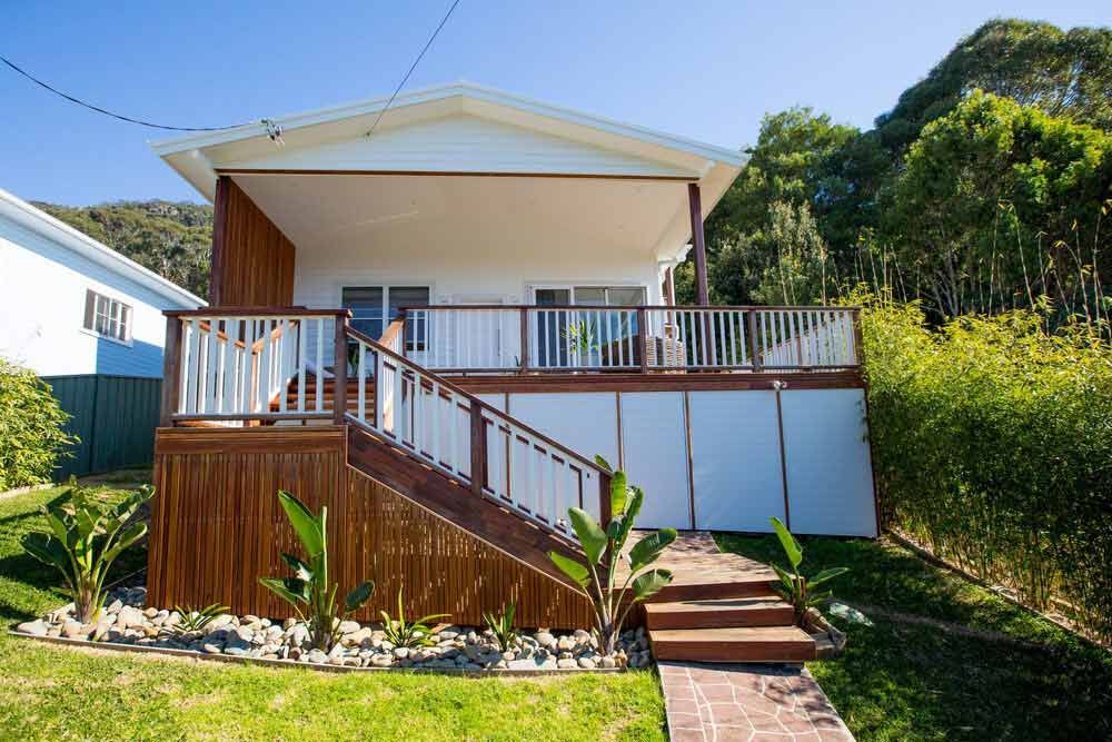 A House With a Large Deck and Stairs Leading Up to It — DeBu Studios In Russell Vale, NSW
