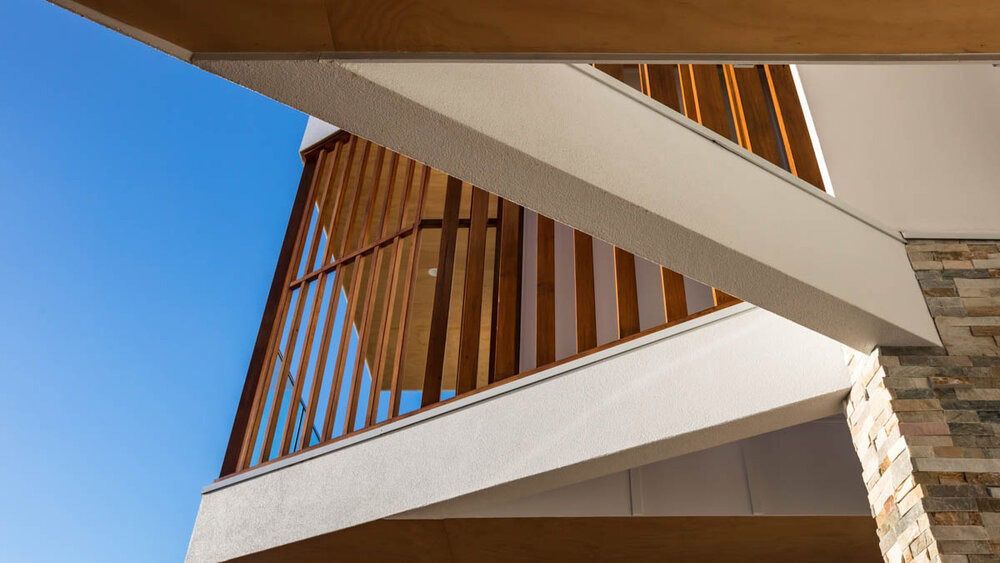 Looking Up at a Balcony on a Building With a Blue Sky in the Background — DeBu Studios In Russell Vale, NSW