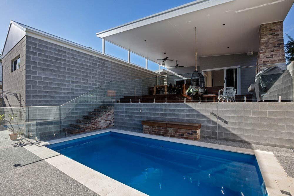 A Large Swimming Pool is in the Backyard of a House — DeBu Studios In Russell Vale, NSW